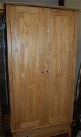 Lot 1144 - A modern laminate double door wardrobe with...