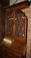 Lot 1146 - An early 19th century mahogany bureau bookcase,...