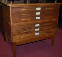 Lot 1183 - An Art Deco oak six drawer plan chest, raised...
