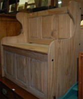 Lot 1193 - A modern pine three panelled hinge-top settle