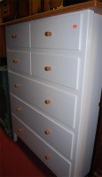 Lot 1198 - A modern pine and white laminate chest of four...