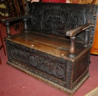 Lot 1205 - A circa 1900 heavily carved low relief oak...