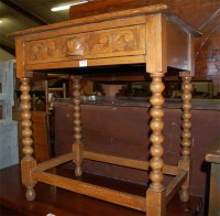 Lot 1213 - A circa 1900 carved oak single drawer side...