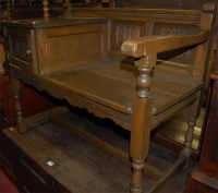 Lot 1216 - A moulded oak telephone seat