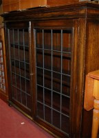 Lot 1229 - A 1930s oak and lead glazed double door...