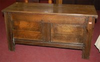 Lot 1236 - An antique joined oak twin panelled hinge-top...