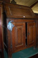 Lot 1237 - An antique joined oak slopefront writing bureau