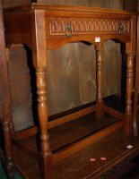 Lot 1242 - A reproduction moulded oak credence shaped...