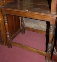 Lot 1254 - An antique joined oak side table raised on...