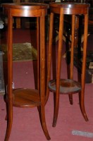 Lot 1261 - A pair of Edwardian walnut circular two tier...