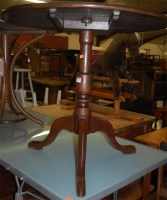 Lot 1300 - A George III oak circular tilt top tripod table