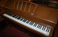 Lot 1332 - A 1970s Eavestaff teak upright piano, iron...