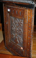 Lot 1334 - A low relief joined and carved oak hanging...