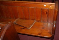 Lot 1379 - A late Victorian stained pine church pew, of...