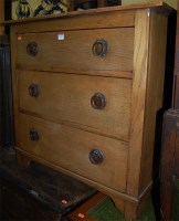 Lot 1395 - An Arts & Crafts oak chest of three long...