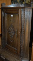 Lot 1396 - A low relief carved oak hanging single door...