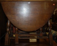 Lot 1408 - An oak dropleaf dining table, having gateleg...