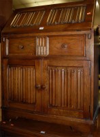Lot 1409 - A linenfold moulded oak slopefront writing bureau