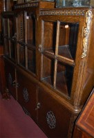 Lot 1418 - A 1930s moulded oak bookcase, having three...