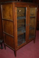 Lot 1425 - A 1930s oak double door glazed bookcase