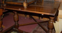 Lot 1284 - A 1930s walnut drawer leaf dining table