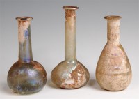 Lot 90 - Three Roman iridescent glass flasks, each with...