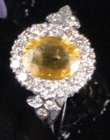 Lot 189 - A contemporary 18ct white gold yellow sapphire...