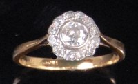 Lot 221 - An 18ct gold platinum and diamond cluster ring,...