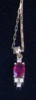 Lot 231 - A 9ct gold ruby and diamond set pendant, on...