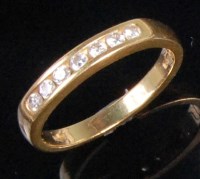 Lot 233 - A modern 18ct gold and diamond half eternity...
