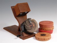 Lot 256 - An Edwardian Kinora-viewer on folding oak...