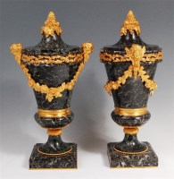 Lot 270 - A pair of variegated blue marble pedestal urns,...