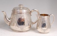 Lot 1200 - A mid-Victorian silver teapot with matching...