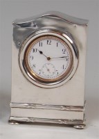 Lot 1212 - An Edwardian silver cased mantel clock, having...