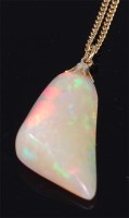 Lot 1252 - A heavily polished opal pendant on 14ct gold...