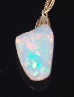 Lot 1253 - A heavily polished opal pendant on 14ct gold...