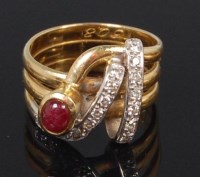 Lot 1257 - A modern 18ct gold ruby and diamond dress ring,...