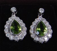 Lot 1276 - A pair of ladies 18ct white gold green peridot...