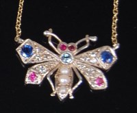 Lot 1284 - An 18ct gold precious set butterfly pendant on...