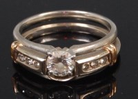 Lot 1310 - An American platinum diamond set dual ring,...