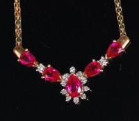 Lot 1323 - A modern 10ct gold pink sapphire and diamond...