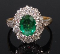 Lot 1326 - A ladies 18ct gold emerald and diamond cluster...