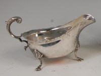 Lot 1205 - A Georgian style silver sauceboat, having...