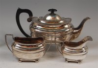 Lot 1209 - A George V silver three piece teaset, in the...