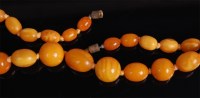 Lot 1246 - A butterscotch amber beaded necklace, 37g, the...