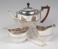 Lot 662 - A late Victorian silver teapot, of half reeded...