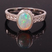 Lot 707 - An 18ct white gold opal and diamond dress ring,...