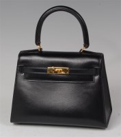 Lot 250 - A Hermés small black leather Kelly bag, with...