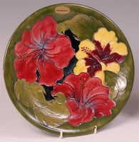 Lot 25 - A Moorcroft Hibiscus pattern pottery plate,...