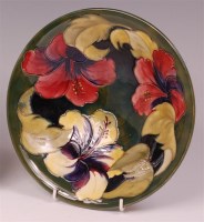 Lot 26 - A Moorcroft Hibiscus pattern pottery circular...